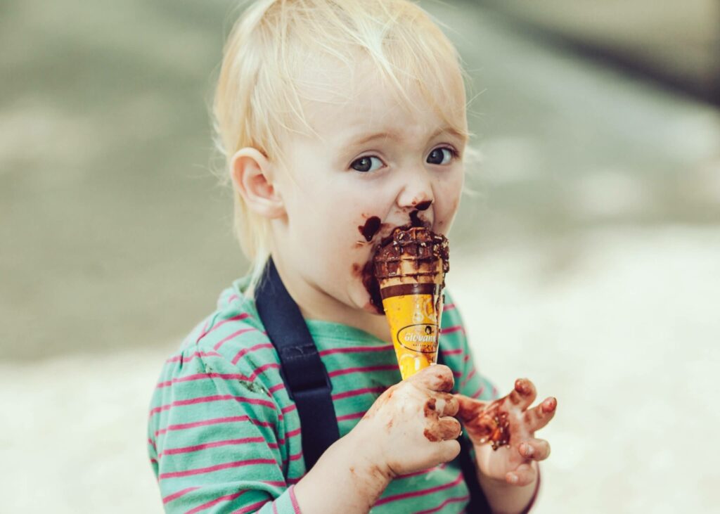 Small boy with ice cream all over his face